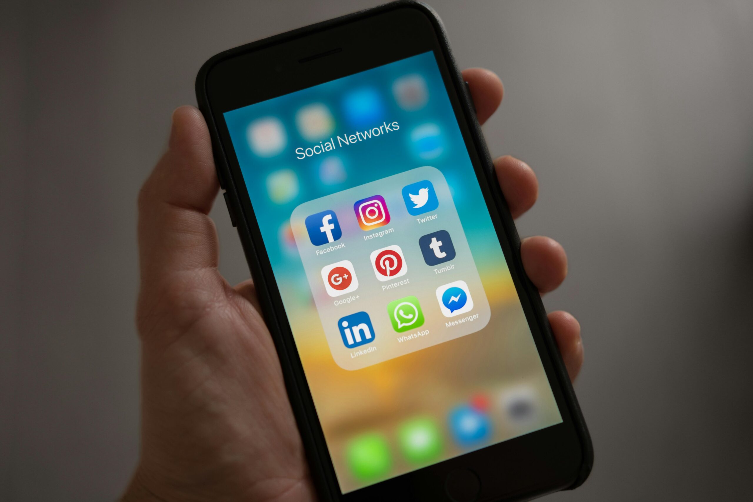 Smartphone screen displaying popular social media apps like Facebook, Instagram, Twitter, LinkedIn, WhatsApp, and Pinterest